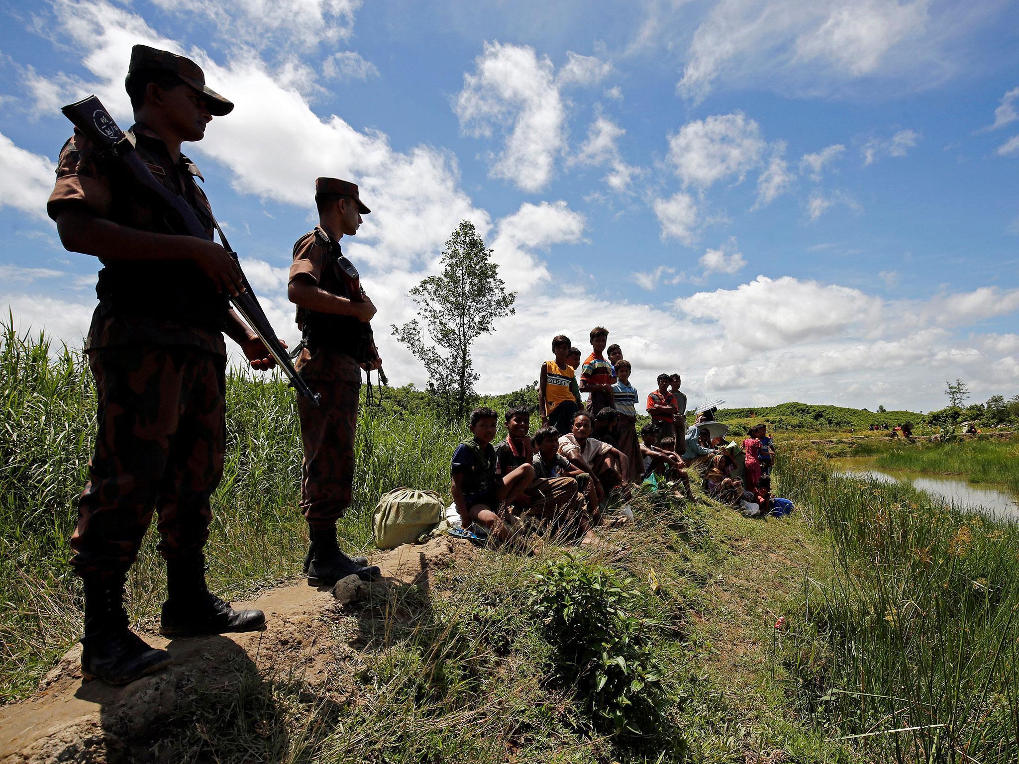 Members of Border Guard Bangladesh stand guard to prevent Rohingya Muslims crossing the Bangladesh border, in Cox's Bazar, Bangladesh