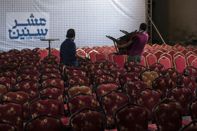 Palestinian labourers prepare the hall for the screening of "10 Years" at Gaza's Samer Cinema