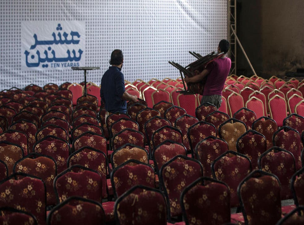Palestinian labourers prepare the hall for the screening of "10 Years" at Gaza's Samer Cinema