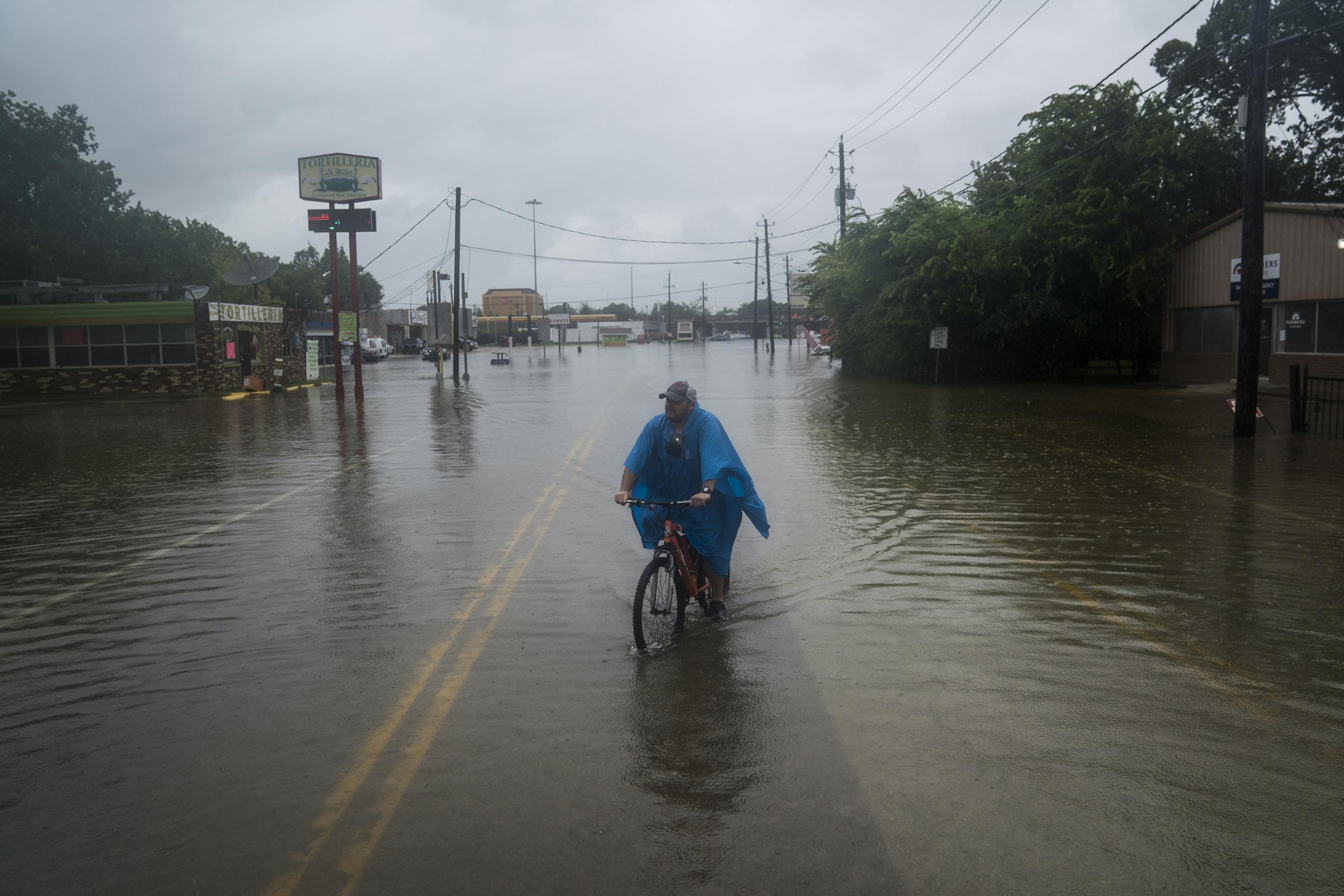 Footage shows moment a driver is rescued from a submerged car in Houston