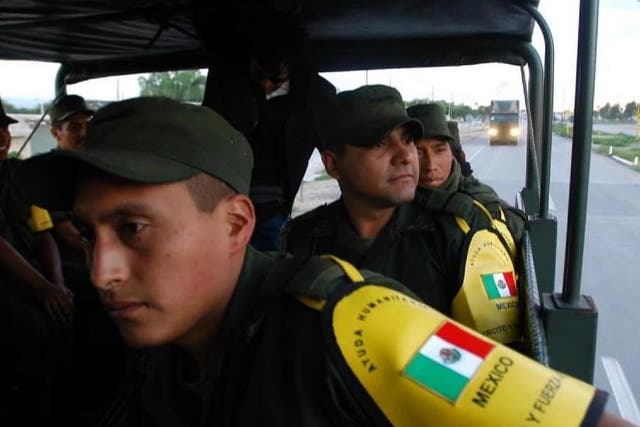 Mexican soldiers en route to the US border on 6 September 2005. The convoy was carrying water-treatment plants, mobile kitchens and supplies for the victims of Hurricane Katrina