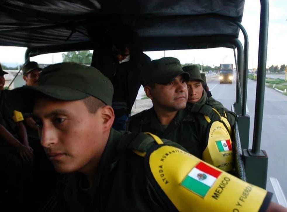 Mexican soldiers en route to the US border on 6 September 2005. The convoy was carrying water-treatment plants, mobile kitchens and supplies for the victims of Hurricane Katrina