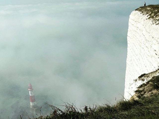 The mist surrounds Beachy Head Lighhouse near Eastbourne on 27 August 2017