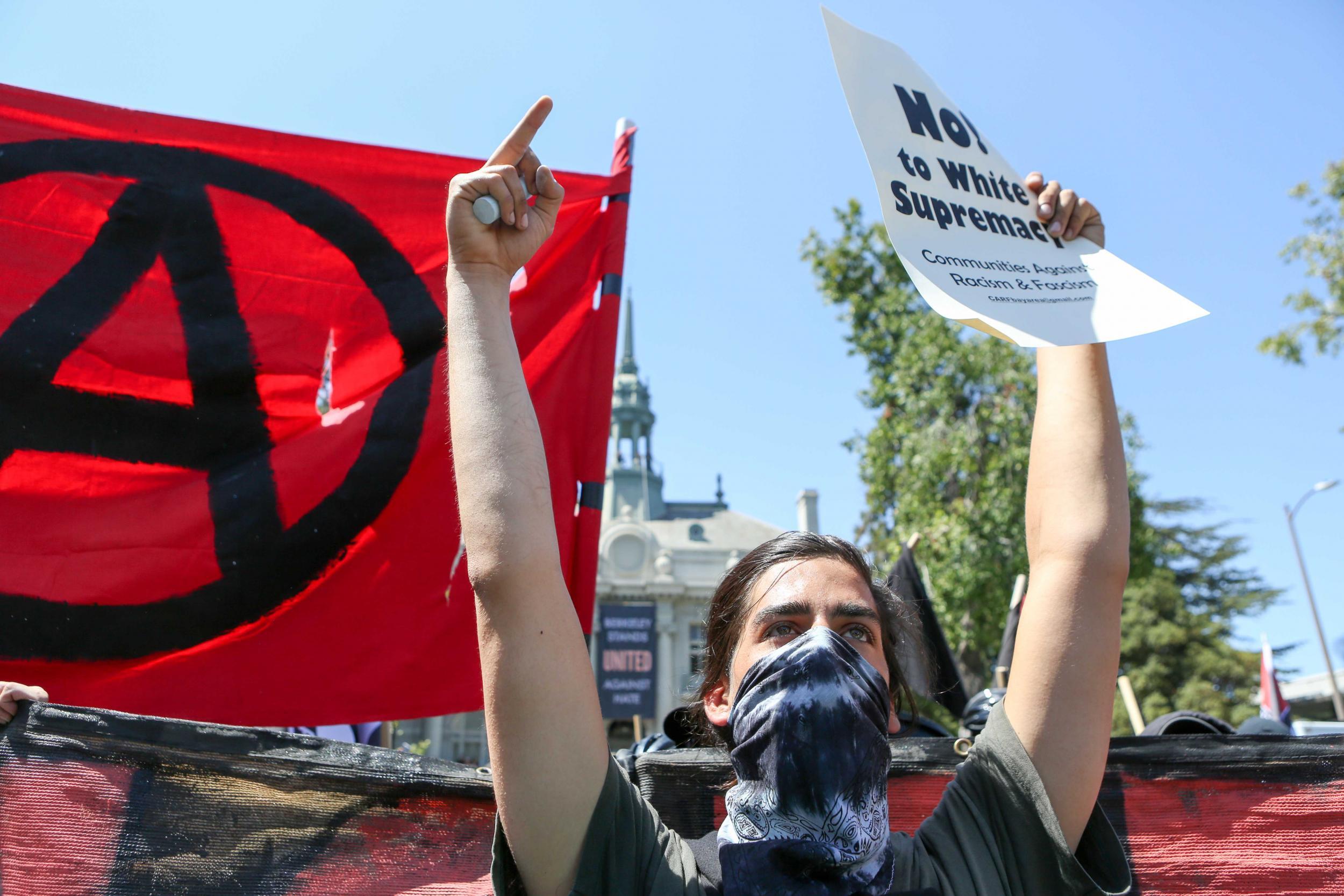 Antifa members and counter protesters gather during a rightwing No-To-Marxism rally on August 27, 2017 at Martin Luther King Jr. Park in Berkeley, California.
