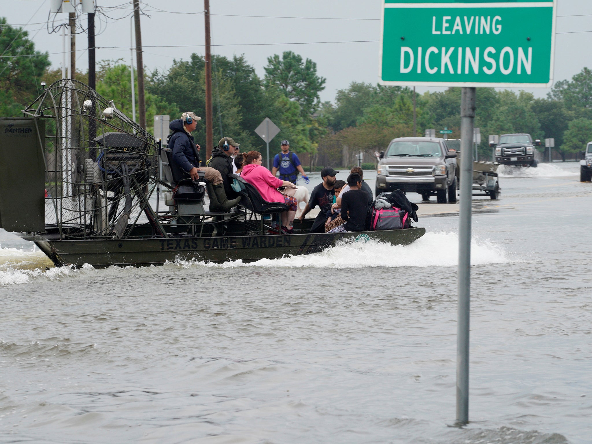 People are rescued by airboat as they evacuate from flood waters after Hurricane Harvey in Dickinson, Texas, in August