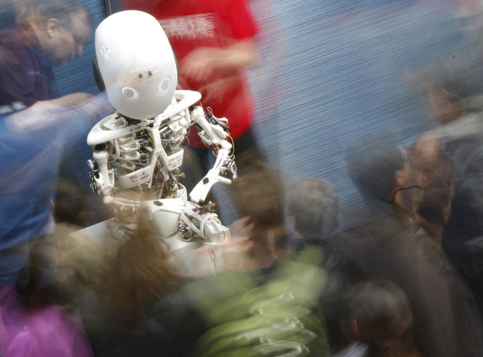 Visitors look at the humanoid robot Roboy at the exhibition 'Robots on Tour' in Zurich, March 9, 2013