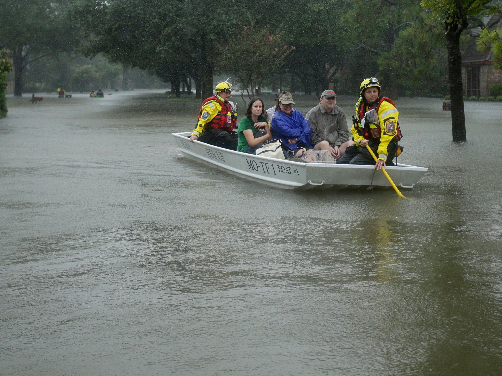 A FEMA rescue team evacuates people from a neighborhood inundated by floodwaters from Tropical Storm Harvey in Houston