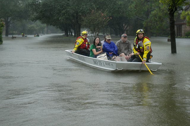 A FEMA rescue team evacuates people from a neighborhood inundated by floodwaters from Tropical Storm Harvey in Houston