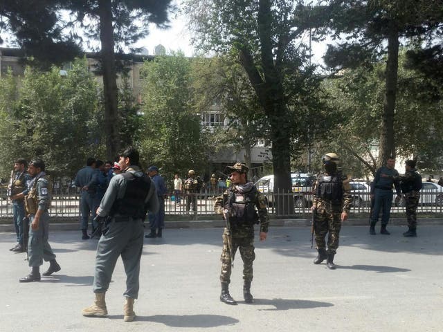 Afghan security forces keep watch at the site of attack in Kabul