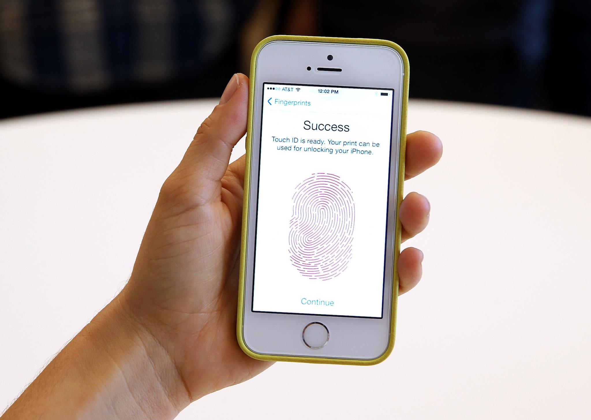The iPhone 5S with fingerprint technology is shown at its product announcement at the Apple campus