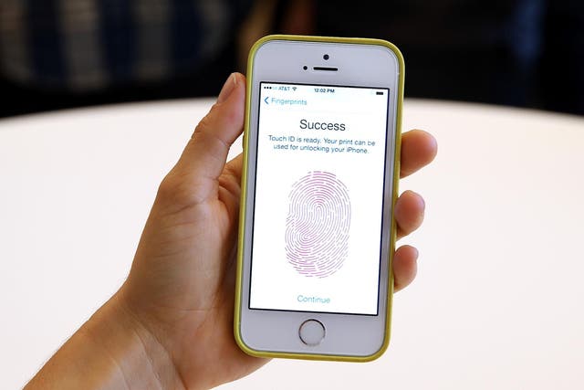 The iPhone 5S with fingerprint technology is shown at its product announcement at the Apple campus