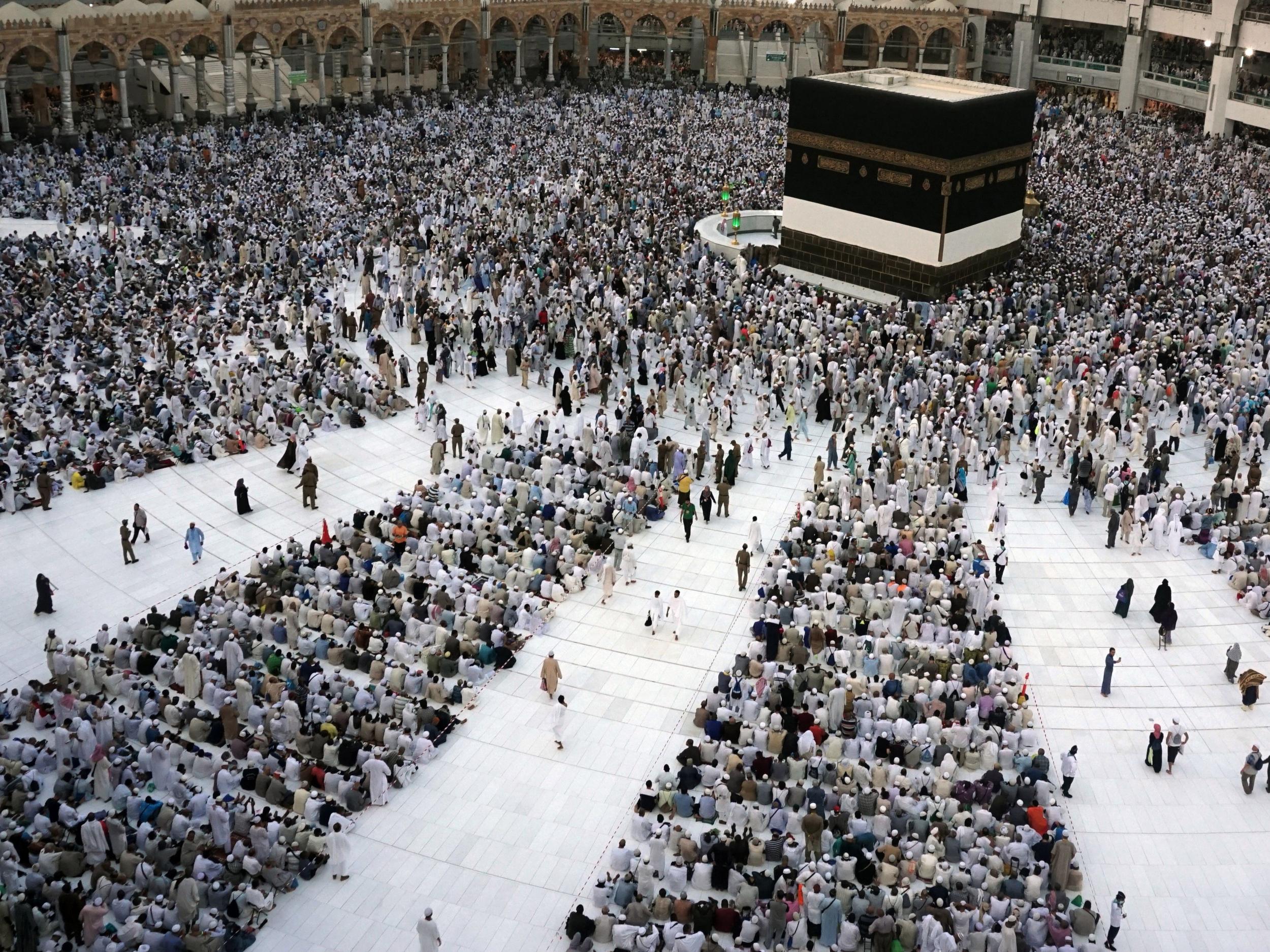 Muslim pilgrims sit around the Kaaba, the cubic building at the Grand Mosque, ahead of the annual Hajj