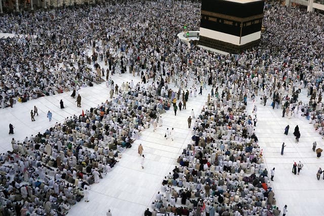 Muslim pilgrims sit around the Kaaba, the cubic building at the Grand Mosque, ahead of the annual Hajj