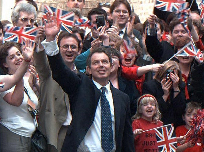 Tony Blair waves to his supporters upon his arrival at Downing Street, after winning the 1997 general election against John Major