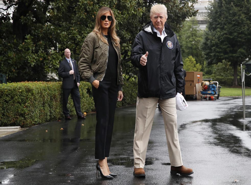President Donald Trump, accompanied by first lady Melania Trump, gives a thumbs-up as they walk to Marine One on the South Lawn of the White House