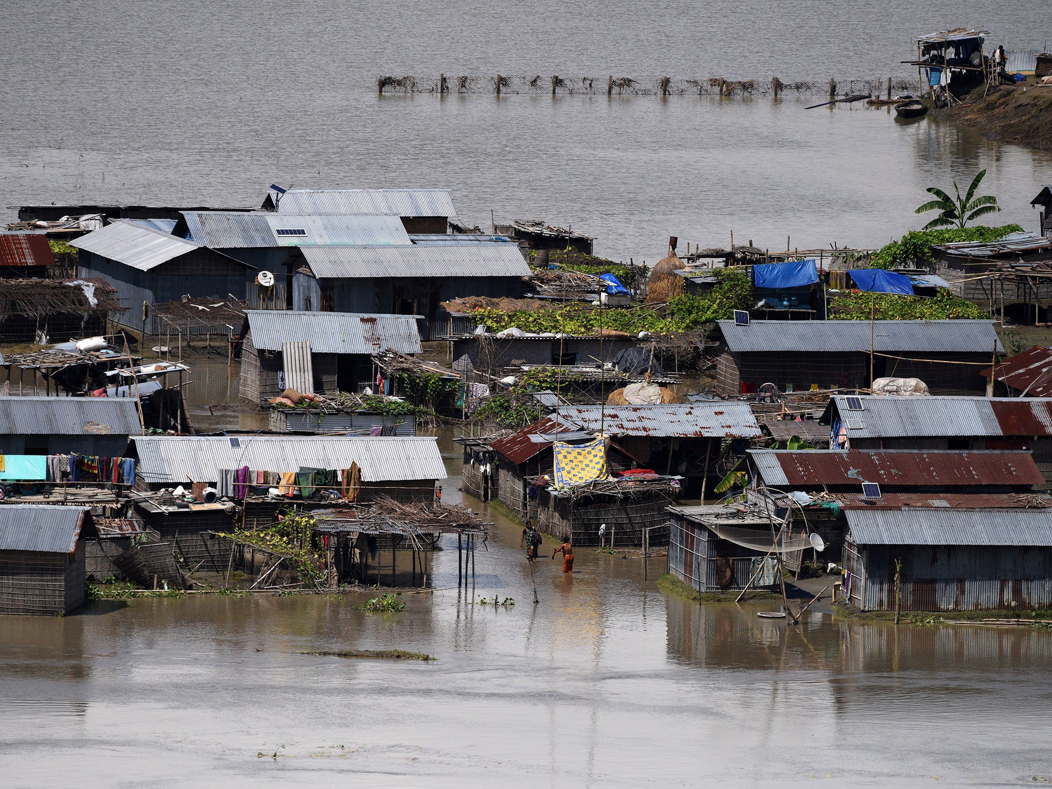 Partially submerged houses are seen at a flood-affected village in Morigaon district in the northeastern state of Assam, India.