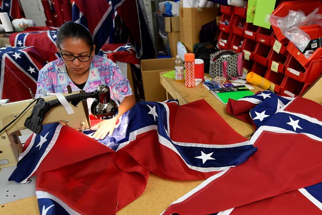 Blanca Hernandez sews stars on a Confederate Battle Flag in the Alabama Flag & Banner shop in Huntsville, Alabama, US