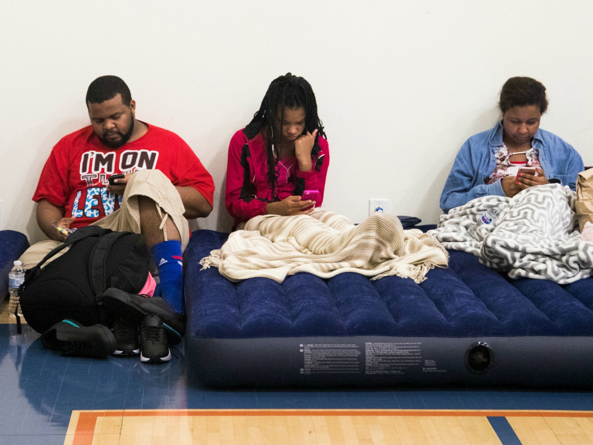 Storm Harvey evacuees rest inside the Lakewood Church after the church opened their doors to the victims