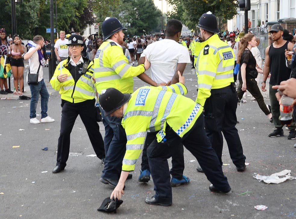 Police holding a man during the second and final day of the Notting Hill Carnival in west London