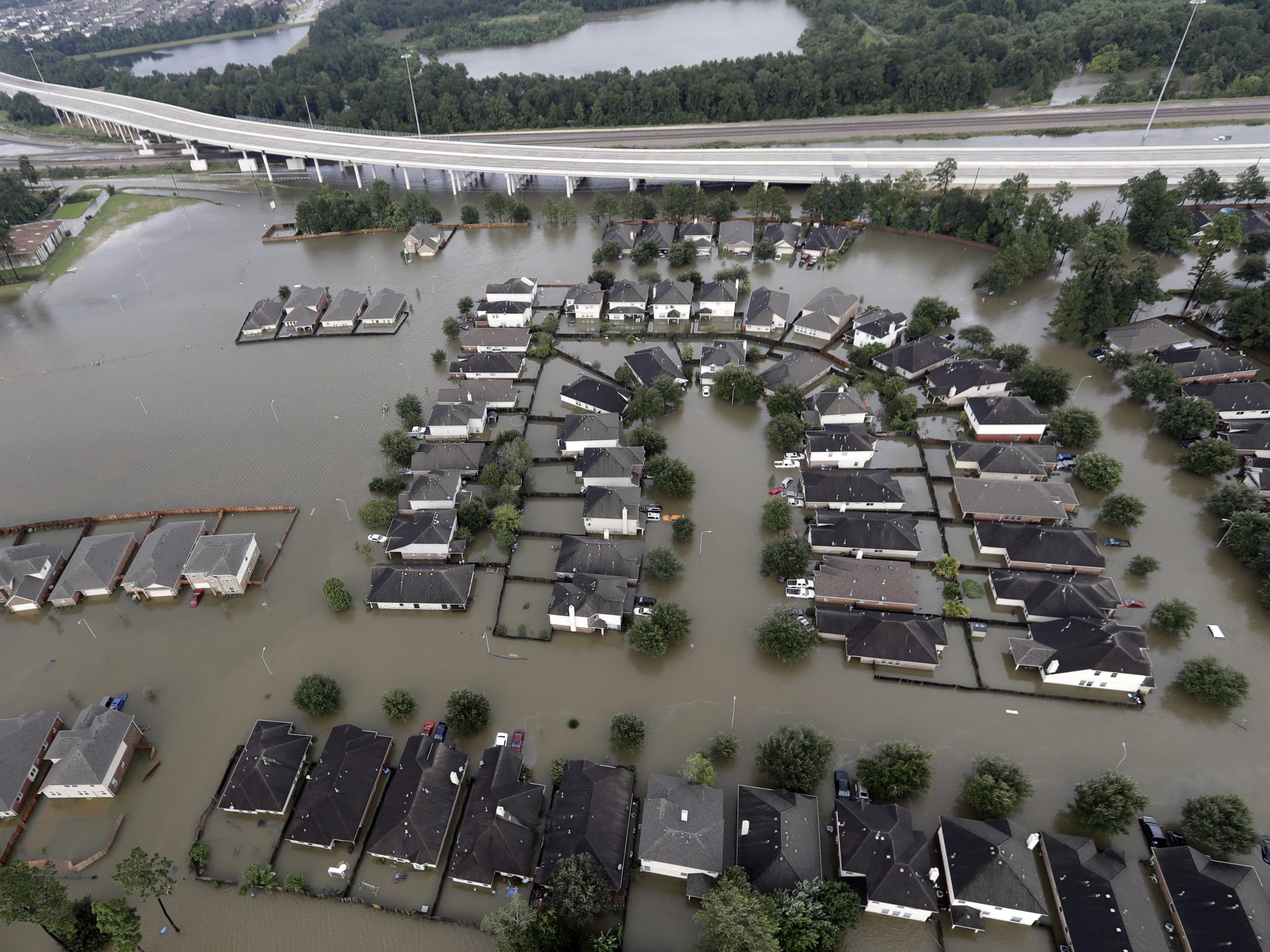 Homes are surrounded by floodwaters from Tropical Storm Harvey