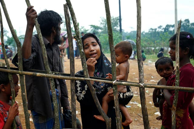 A Rohingya refugee woman cries as they arrive at the Kutupalang makeshift Refugee Camp in Cox's Bazar, Bangladesh