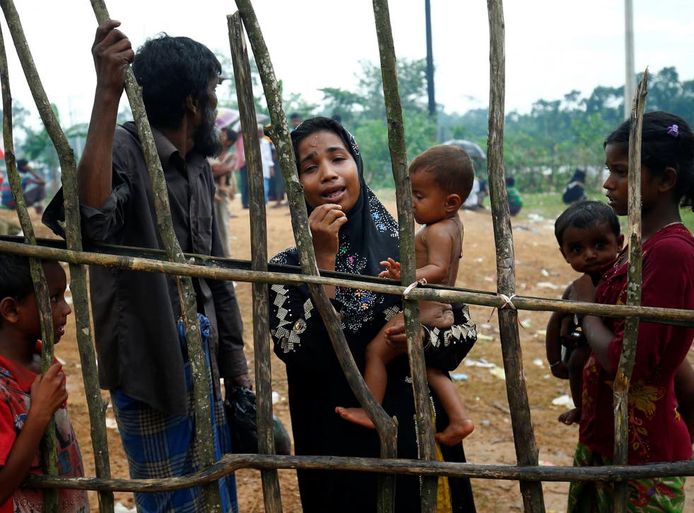 A Rohingya refugee woman cries as they arrive at the Kutupalang makeshift Refugee Camp in Cox's Bazar, Bangladesh
