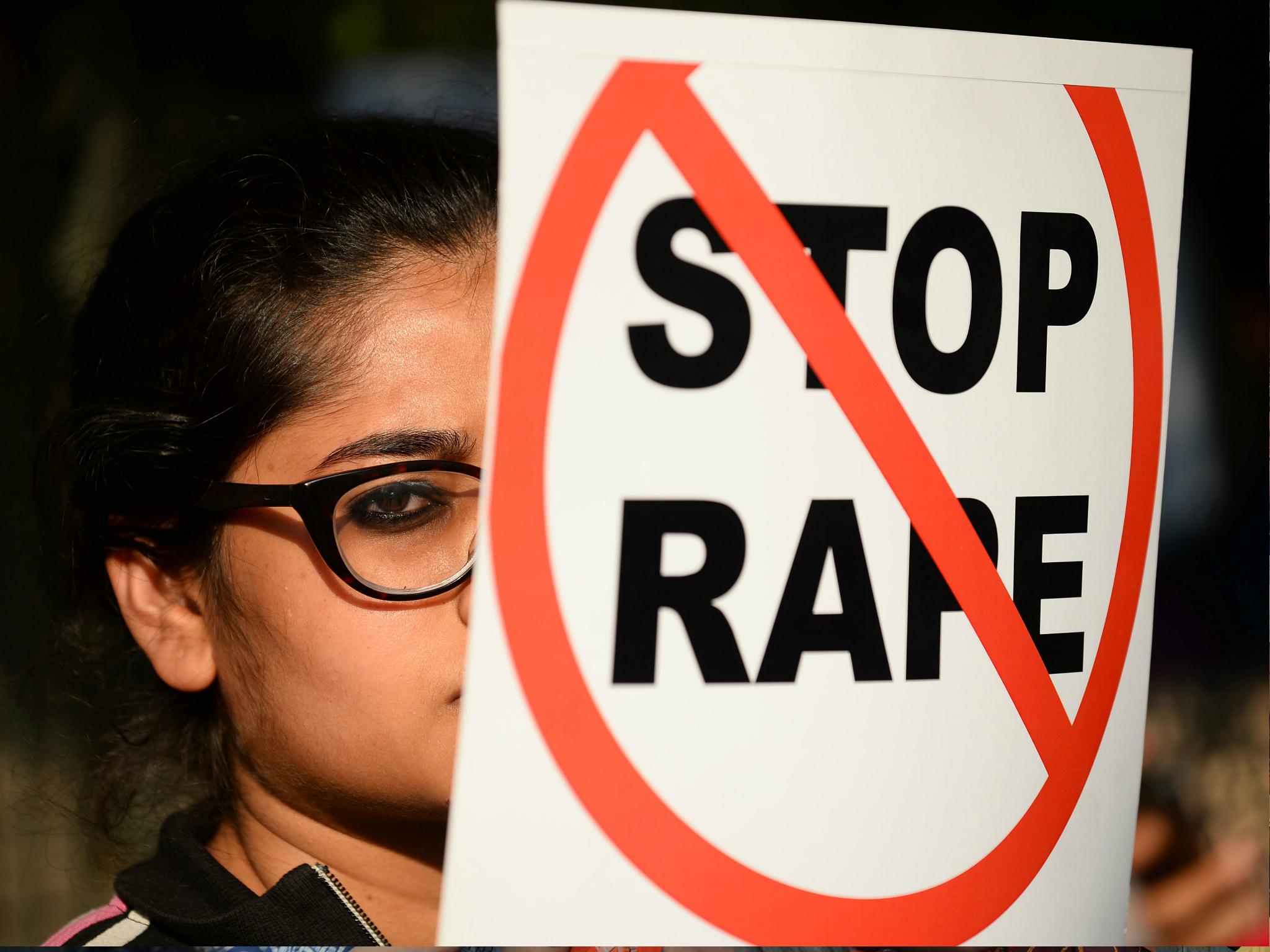 An Indian social activist holds a placard during a protest against a rape at Hauz Khas village in New Delhi on 21 February 2017.