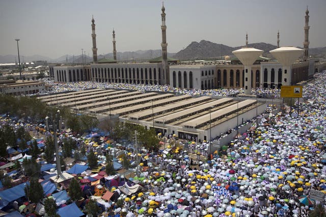 Muslim pilgrims hold umbrellas as they attend noon prayers outside the Namirah mosque on Arafat Mountain during the annual Hajj pilgrimage outside the holy city of Mecca, Saudi Arabia