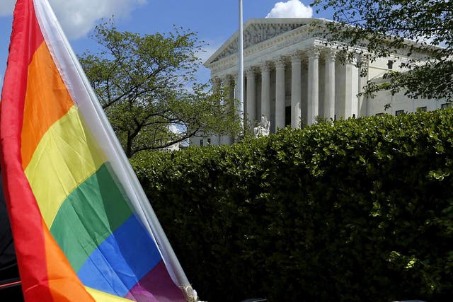 A rainbow coloured flag is seen outside the US Supreme Court in Washington