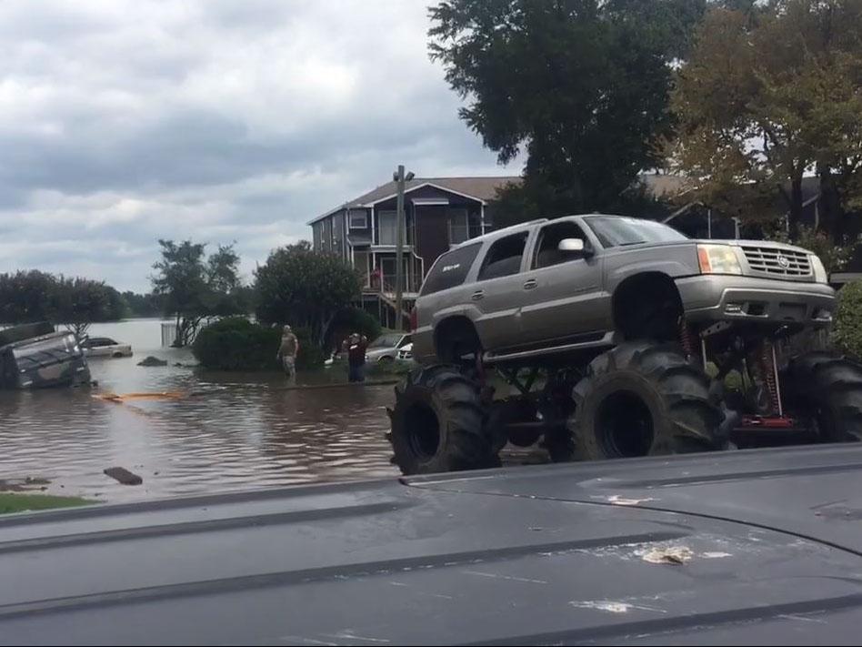 One large-wheeled vehicle pulled an army lorry from the flood waters