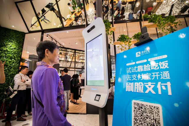 A customer tries Alipay's facial recognition payment solution "Smile to Pay" at KFC's new KPRO restaurant in Hangzhou, Zhejiang province, China