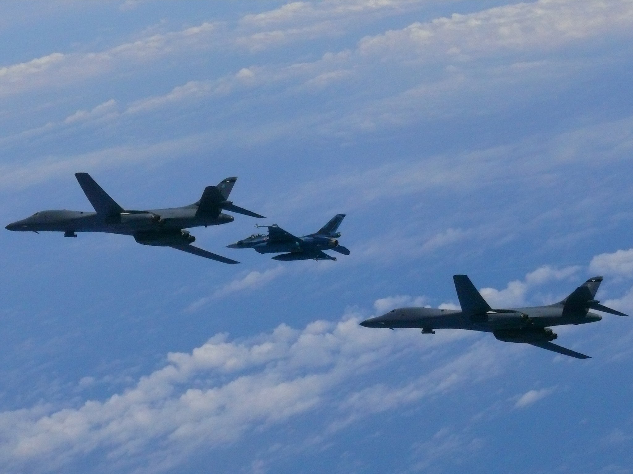 Two US Air Force B-1B Lancer bombers fly with a Japan Air Self-Defense Force F-2 fighter jet over the East China Sea