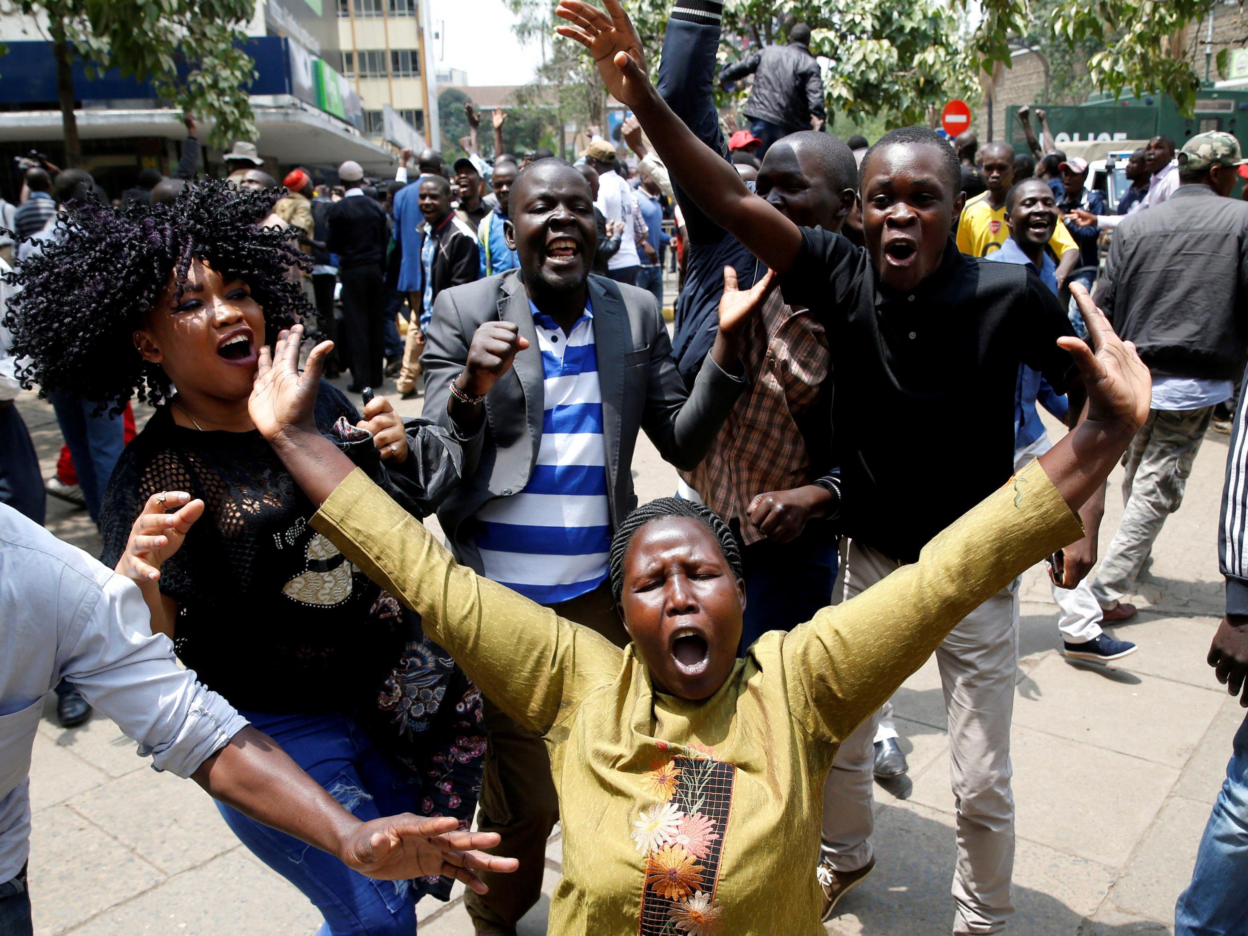 Supporters of opposition leader Raila Odinga cheer outside court after President Uhuru Kenyatta's election win was declared invalid in Nairobi