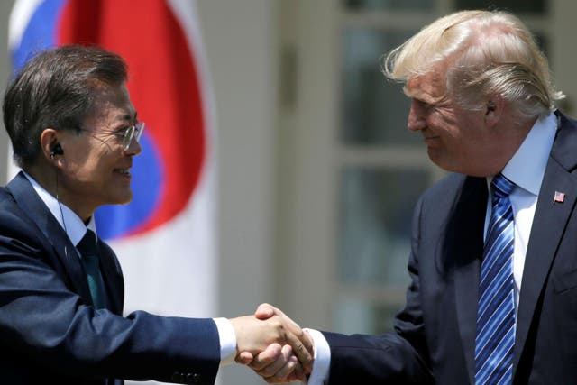 Moon Jae-in and Donald Trump shake hands