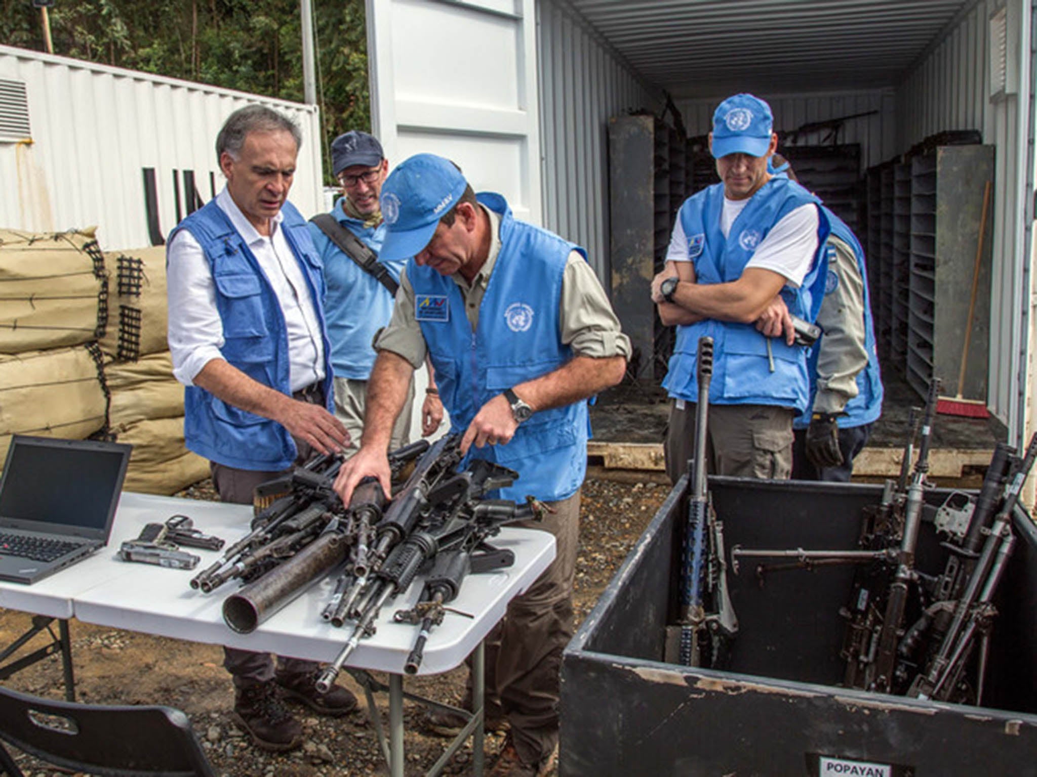 &#13;
UN staff examine weapons handed in by former &#13;