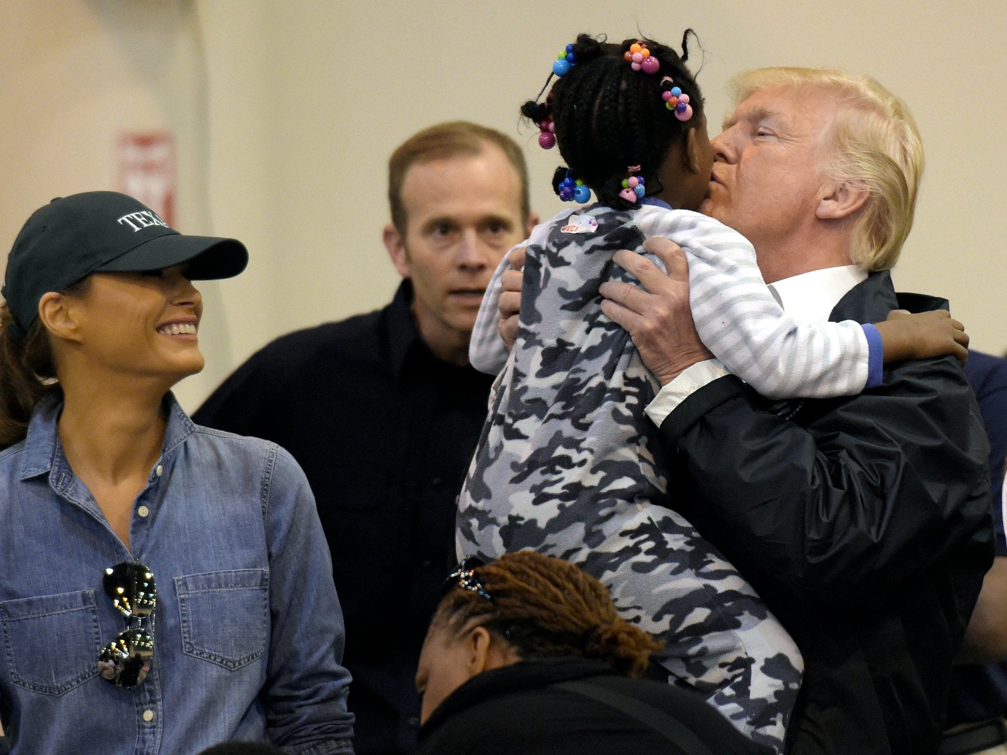President Donald Trump and Melania Trump meet a child impacted by Hurricane Harvey during a visit to the NRG Center in Houston