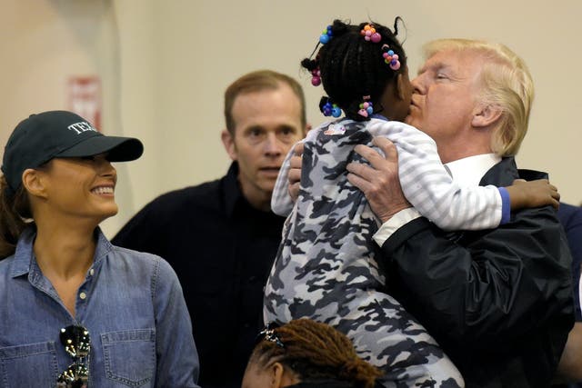 President Donald Trump and Melania Trump meet a child impacted by Hurricane Harvey during a visit to the NRG Center in Houston