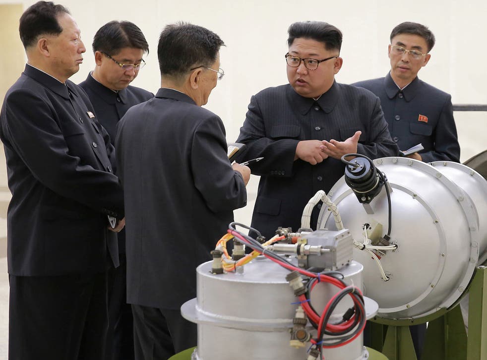 Photos released by North Korea appear to show Kim Jong-un talking to subordinates next to a device thought to be the new thermonuclear weapon