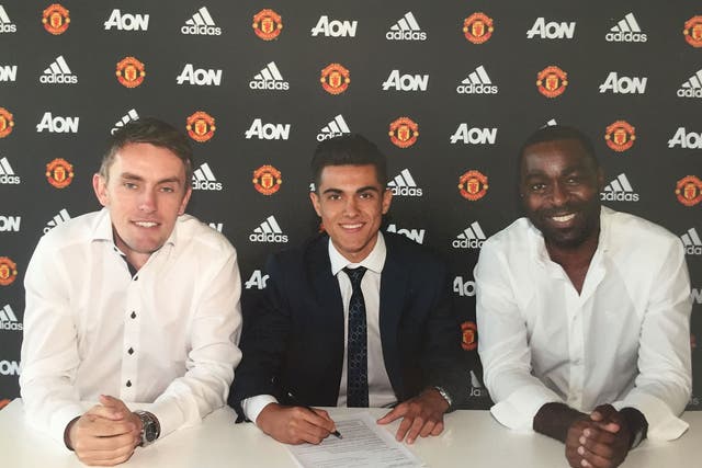 Arnau Puigmal signs his Manchester United contract alongside Kieran McKenna and Andy Cole