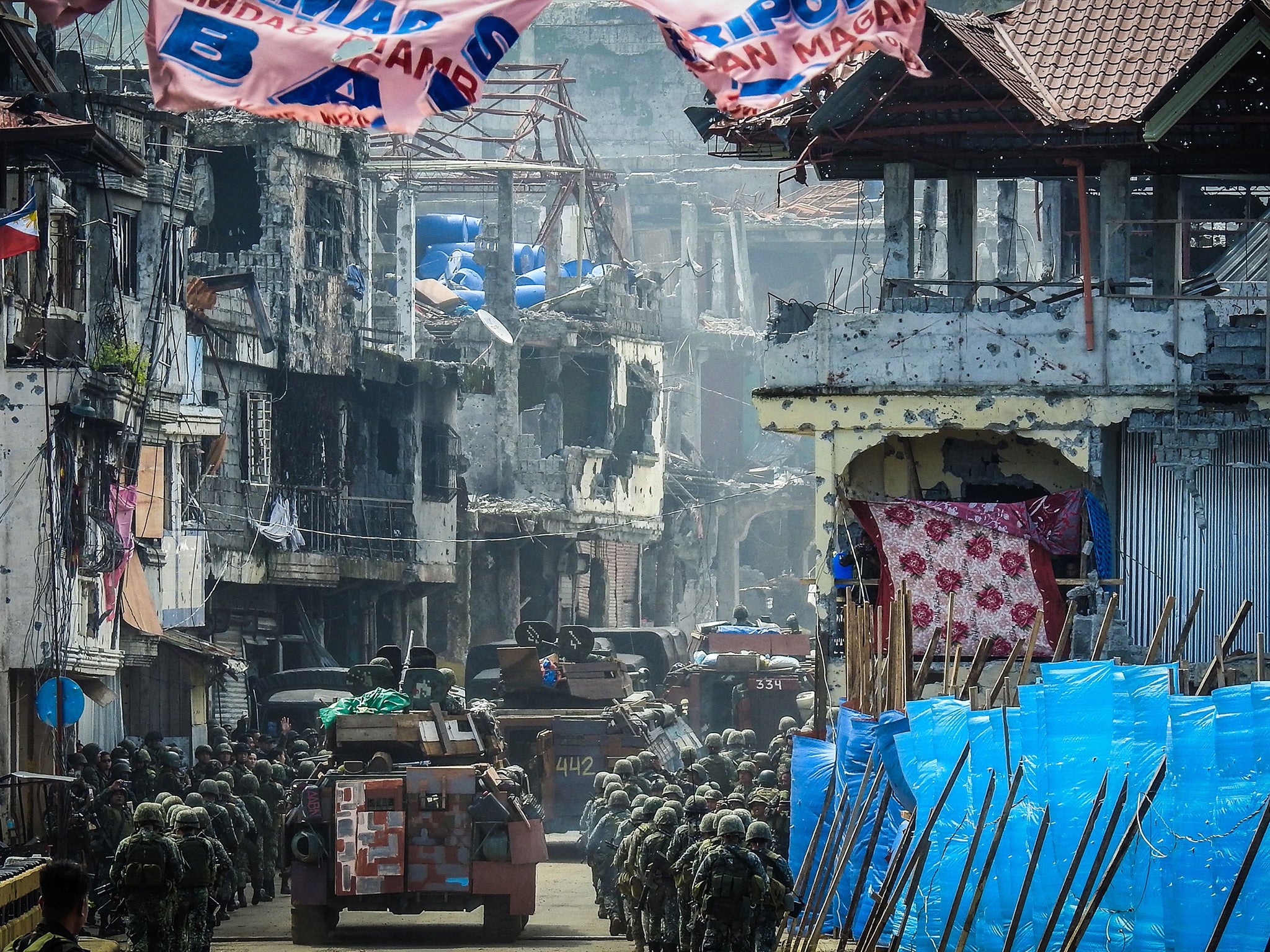 Filipino troops marching through Marawi City last week. The army is struggling to push out the last remaining insurgents from the city