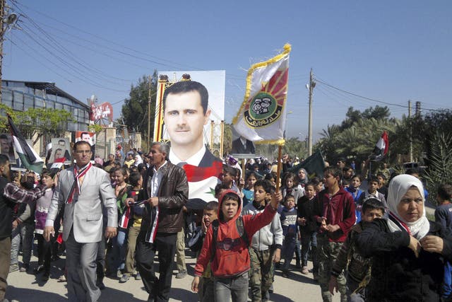 Residents in Deir Ezzor at a 2014 rally to support Syria's President Bashar al-Assad, before the town was beseiged by Isis militants