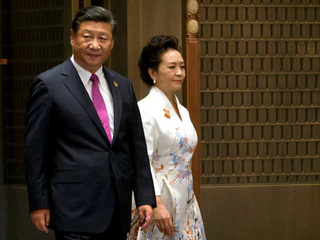 Chinese President Xi Jinping and his wife Peng Liyuan arrive at a summit with Russia, India, Brazil and South Africa in southeast China, with domestic and international issues on his mind Mark Schiefelbein/AP