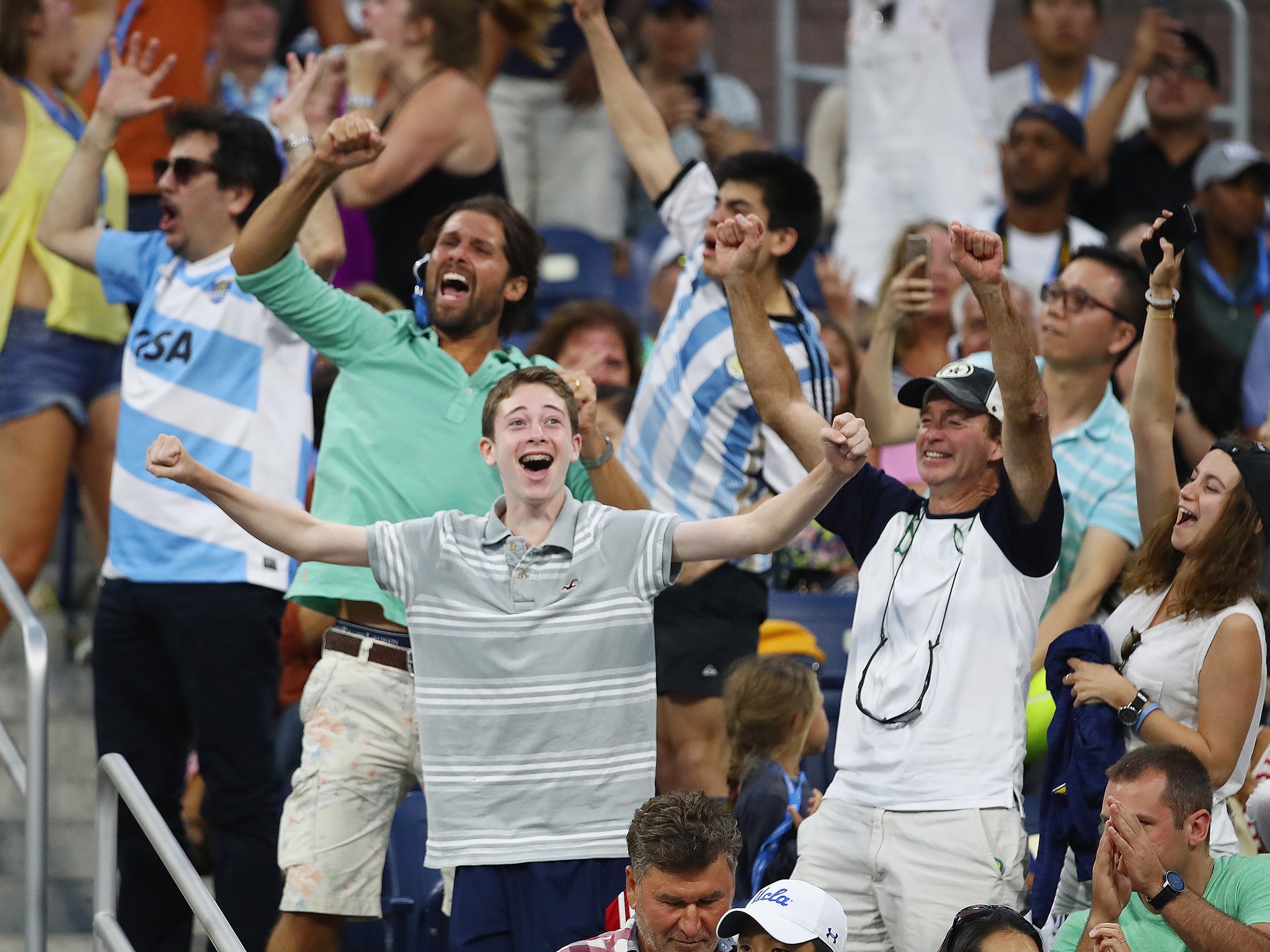 Fans dressed in Argentinian football shirts celebrated after Del Potro's victory