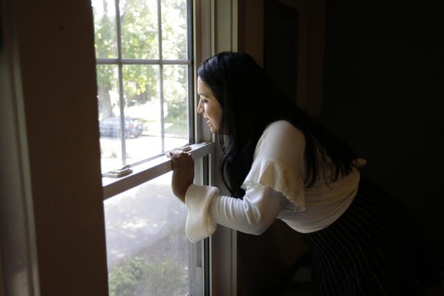 Ninotska Love, who has been accepted at Wellesley College, looks out a window in her dorm room at the women's school in Wellesley, Massachusetts