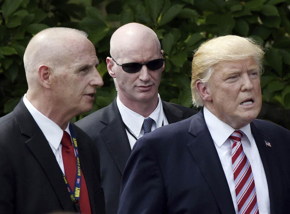 Keith Schiller (left), Deputy Assistant to the President and Director of Oval Office Operations, talks to President Donald Trump on the South Lawn of the White House in June