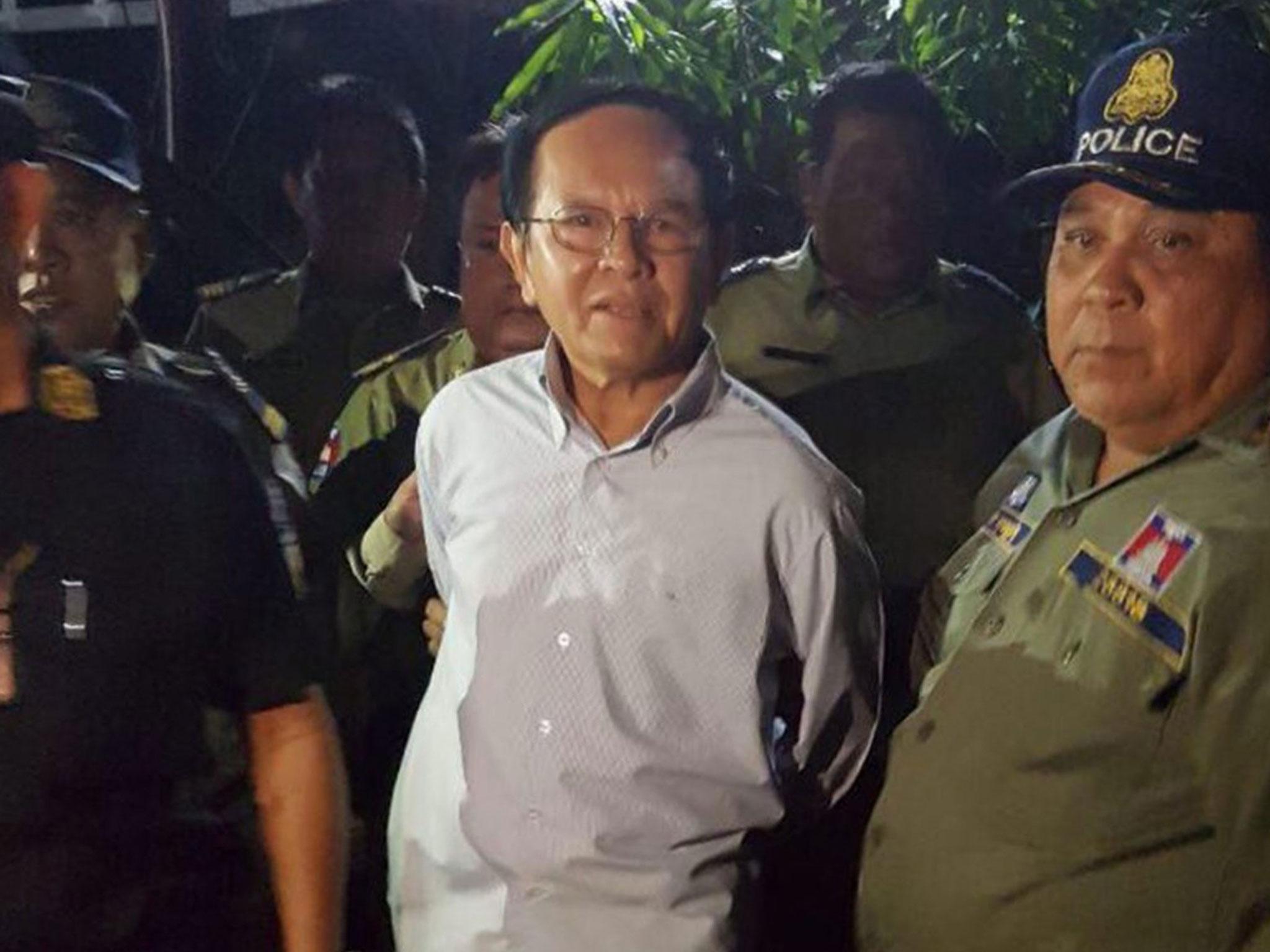 Cambodia's opposition leader Kem Sokha, 64, is detained during a police ride at his home in Phnom Penh, Cambodia