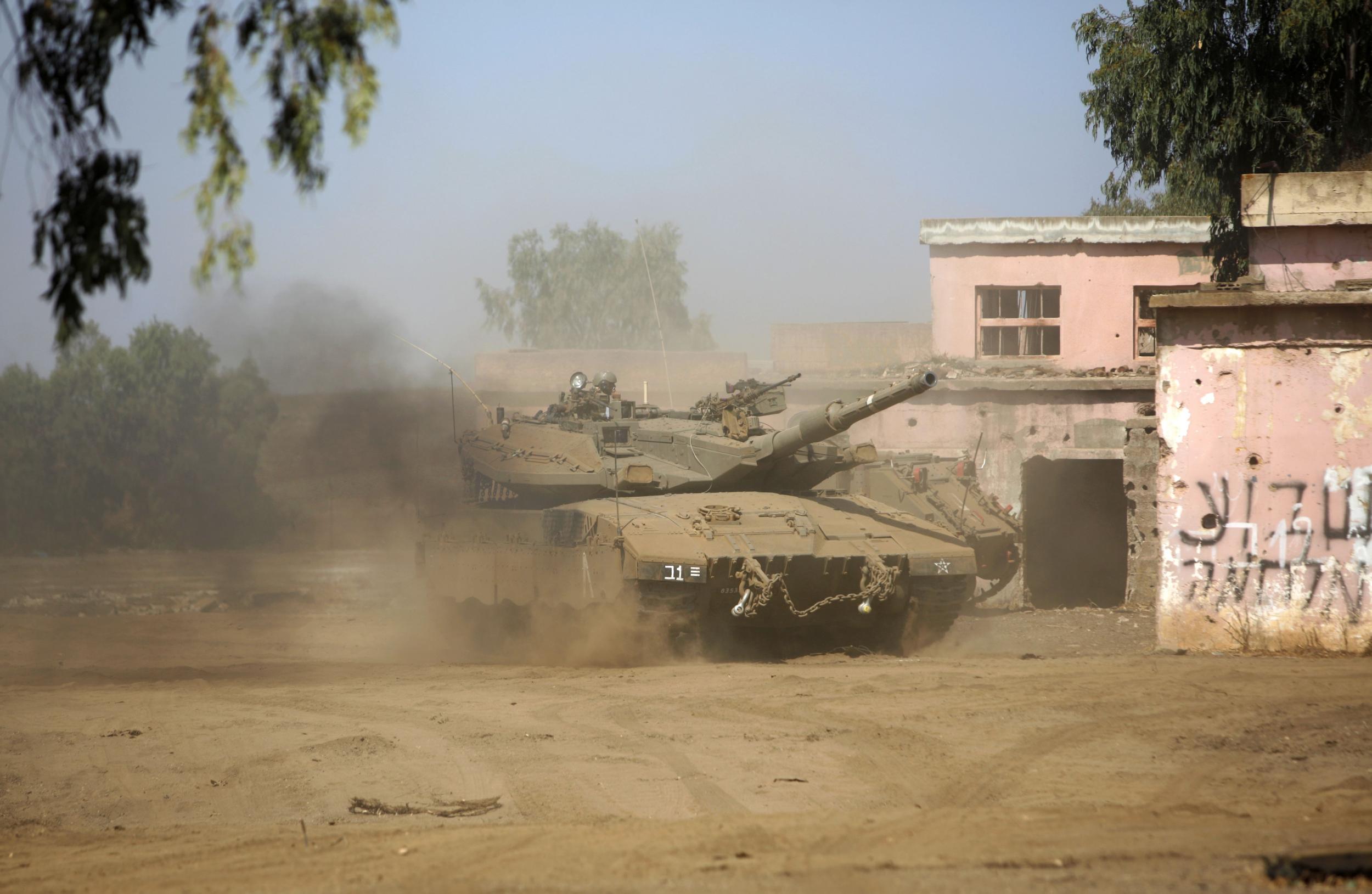 Israeli army tanks manoeuvre during a military exercise simulating conflict with Lebanese movement Hezbollah, in the Israeli annexed Golan Heights near the Syrian border on 5 September 2017