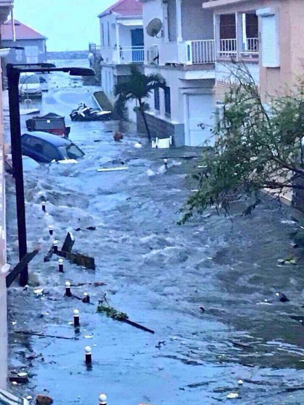 A torrent runs along a street in Saint Martin