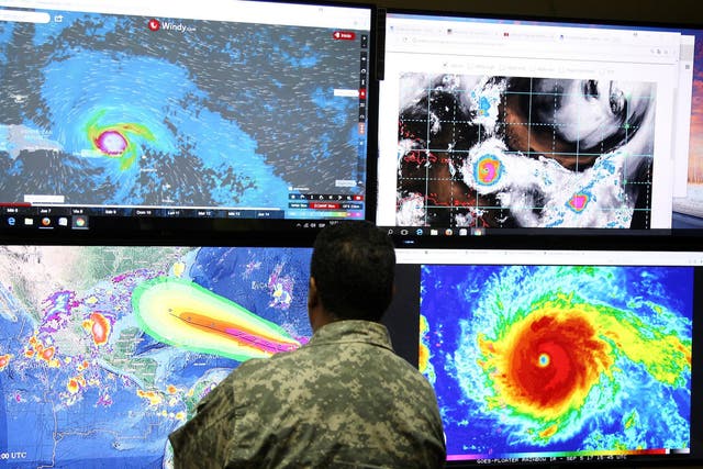 A member of the Emergency Operations Committee (COE) monitors the trajectory of Hurricane Irma in Santo Domingo, Dominican Republic September 5, 2017