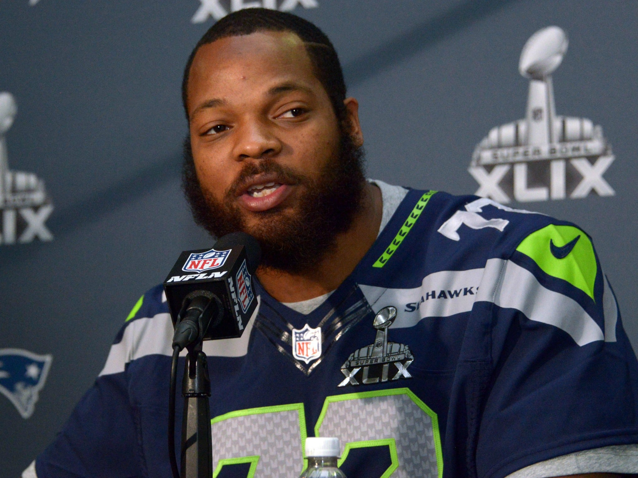 Seattle Seahawks defensive end Michael Bennett, seen here during a Jan 29, 2015 press conference, contends he was mistreated by the Las Vegas police.